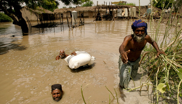 Pakistani flood survivors wait their turn to get relief food distributed by naval officials in Sangi Village near Sukkur, in southern Pakistan on August 19, 2010. Pakistan's economy has been hammered by the flooding, and climate-related disasters like Pakistan's will inevitably hurt the U.S. economy and businesses. (AP/Shakil Adil)