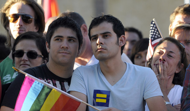 Gay marriage supporters listen at a public rally on August 4, 2010 in West Hollywood, CA. Many religious groups issued statements in support of California Judge Vaughn Walker's decision yesterday to overturn the state's ban on same-sex marriage. (AP/Adam Lau)