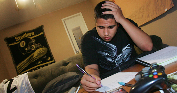 States have been using much-needed TANF Emergency Fund dollars on programs such as summer jobs for youth. Cameron Hinojosa, pictured here, works on homework and his resume at home in the hope of finding landing a job. (AP/Gary Kazanjian)