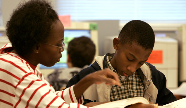 An African-American woman helps her son with his homework at a library in Richmond, VA. Unmarried women are less economically secure than their married counterparts in terms of jobs, wealth, and wages, and these problems are worse for single women of color. (AP/Steve Helber)