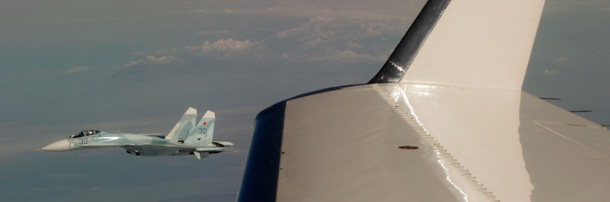 A Russian Su-27 fighter jet flies alongside a civilian airplane playing the role of a hijacked airlinerin a joint exercise between Canada, the United States, and Russia on August 8, 2010. (AP/Ted S. Warren)