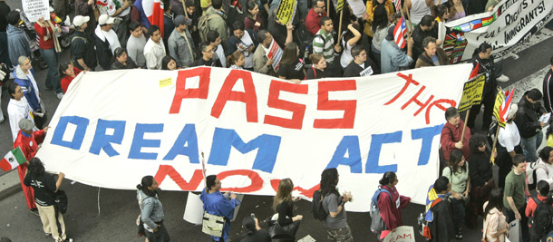 Students and immigrants march toward the federal building in New York carrying a sign that calls for passing the Dream Act, a bill that would open a path to immigration for college-bound students who have lived most of their lives in the United States but lack legal immigrant status. (AP/Kathy Willens)