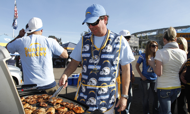 San Diego Chargers fan Frank Cusick turns the chicken on his grill as he and friends enjoy the summer-like weather while tailgating prior to an NFL football game between the Chargers and the Washington Redskins in San Diego.
  (AP/Chris Park)