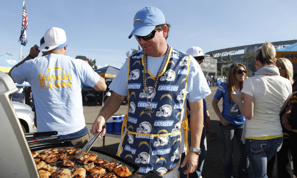 San Diego Chargers fan Frank Cusick turns the chicken on his grill as he and friends enjoy the summer-like weather while tailgating prior to an NFL football game between the Chargers and the Washington Redskins in San Diego.
(AP/Chris Park)