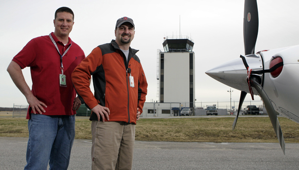 Air traffic controllers  Kevin Plante, left, and Chris Presley, pose near the tower at the Portland International Jetport in Portland, ME. The morale of federal workers has a definite impact on the performance of government agencies and the quality of the services they provide.
  (AP/Robert F. Bukaty)