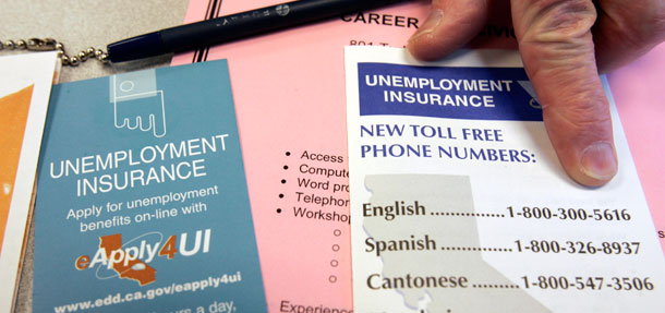 A state worker points out phone numbers for unemployment insurance at the state unemployment and career office in San Francisco. (AP/Paul Sakuma)