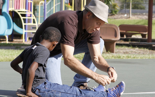 Martin Gill ties the shoelace of his six-year-old son in a park in North Miami on September 22, 2010. A Florida appeals court ruled last month that a state ban on adoption by gay men and lesbians was unconstitutional. (AP/Alan Diaz)