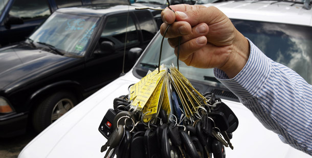 Sales manager Mark Hranicky holds up a bunch of keys to some of the 90 cars that were traded in under the Cash for Clunkers program on a lot at Lee Toyota in Topsham, ME. (AP/Pat Wellenbach)