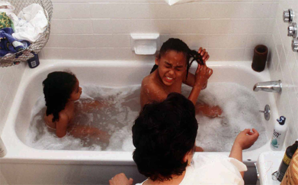 Pat Smith helps her children, Bella, left, and Nina, bathe before bed in San Francisco. (AP/Pico van Houtryve)