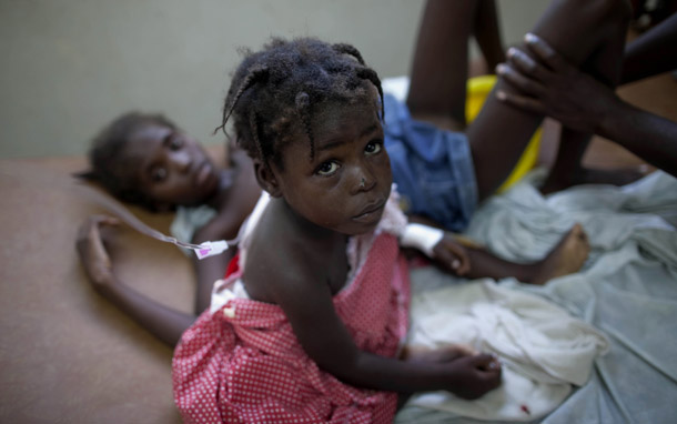 Children suffering cholera symptoms receive serum at a hospital in Marchand Dessalines, Haiti, on October 22, 2010. (AP/Ramon Espinosa)