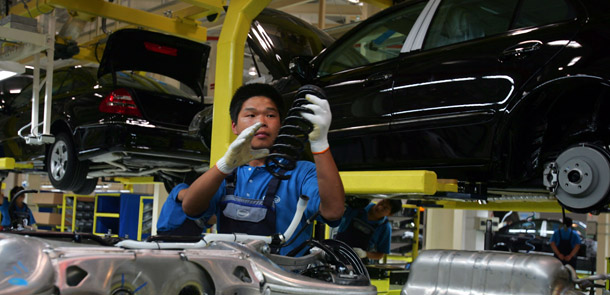 A Chinese factory worker mans the assembly line at DaimlerChrysler's first factory in Beijing. To have a well-functioning economy people need jobs that allow them to work in acceptable working conditions, with appropriate protections and compensation, and with the right to organize and bargain collectively. (AP/Elizabeth Dalziel)