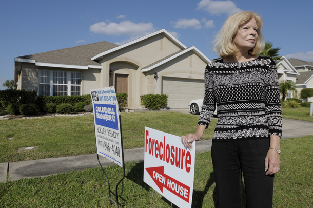 Realtor Dorothy Buse stands in front of a foreclosed home in Kissimmee, FL. Foreclosed homes have now been frozen as banks and mortgage companies review their procedures. (AP/Phelan M. Ebenhack)