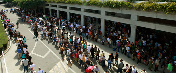 Thousands of people wait in line at the Los Angeles Convention Center for free mortgage help in downtown Los Angeles on September 30, 2010. (AP/Damian Dovarganes)