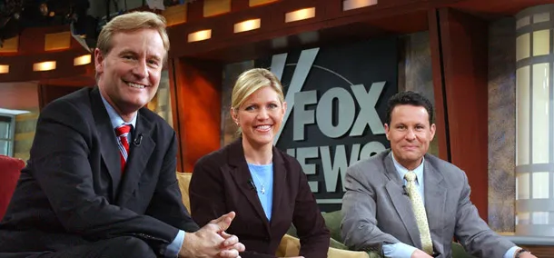 Steve Doocy, left, E.D. Hill, and Brian Kilmeade pose on the set of "Fox & Friends," in New York. (AP/Frank Franklin II)