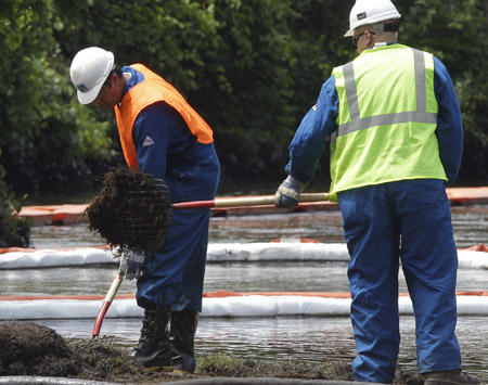 Crews clean up oil from a ruptured pipeline where Talmadge Creek meets the Kalamazoo River in Marshall Township, MI, July 30, 2010. Politics notwithstanding, America’s infrastructure is approaching a crisis point. (AP/Paul Sancya)