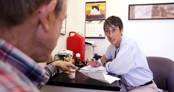 Dr. Lisa Capaldini, right, talks about drugs for AIDS patient Jack Murphy at her office in San Francisco. The AIDS Drug Assistance Program, or ADAP, provides life-saving medications to more than 165,000 uninsured and underinsured Americans living with HIV-AIDS. (AP/Paul Sakuma)