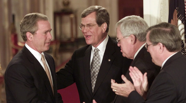 President Bush greets Senate Minority Leader Trent Lott, R-MS, second from left, House Speaker Dennis Hastert, R-IL, and Rep. Bill Thomas, R-CA, right, as he arrives to sign his $1.35 trillion tax cut bill on June 7, 2001. Extending the tax cuts for the top 2 percent of income earners would not create jobs and would bust the budget. (AP/Ron Edmonds)