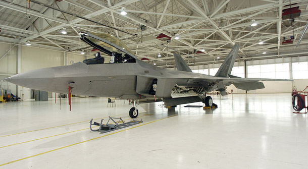 A static display of an F-22 Raptor is seen at Langley Air Force Base in Hampton, VA. Last year’s battle over building additional F-22 Raptor fighter jets illustrated the parochial political interests of individual members of Congress when it comes to defense programs. (AP/Gary C. Knapp)