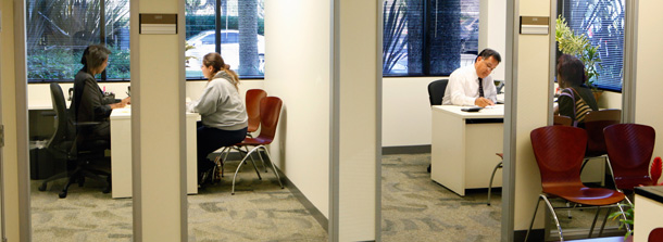 Mortgage help specialists meet with home owners to discuss their loans. (AP/Damian Dovarganes)