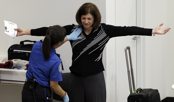 A woman undergoes a pat-down during TSA security screening, Friday, November 19, 2010, at Seattle-Tacoma International Airport in Seattle. (AP/Ted S. Warren)