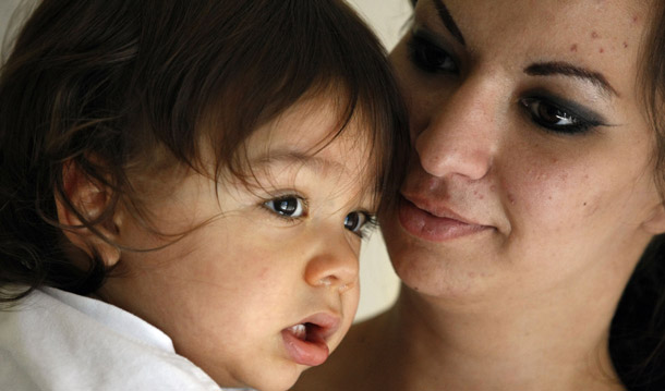 Sarah Notley, right, holds her 17-month-old son Andre while waiting for housing assistance at Sacred Heart Community Center in San Jose, CA, on September 16, 2010. The Great Recession continues to affect many children as well as their parents, and Congress can help make sure children's well-being is maintained. (AP/Marcio Jose Sanchez)