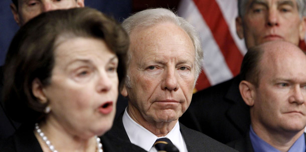 Sen. Joseph Lieberman (I-CT), center, listens to comments by Sen. Dianne Feinstein (D-CA) during a news conference on Capitol Hill in Washington, D.C., on November 18, 2010, to push for the repeal of the