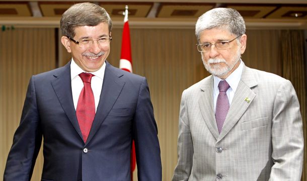 Turkish Foreign Minister Ahmet Davutoğlu, left, talks to the media with his Brazilian counterpart Celso Amorim in Istanbul, Turkey, Sunday, July 25, 2010. Davutoğlu and Amorim voted in support of a diplomatic solution to Iran's nuclear standoff. (AP/Tolga Bozoglu)