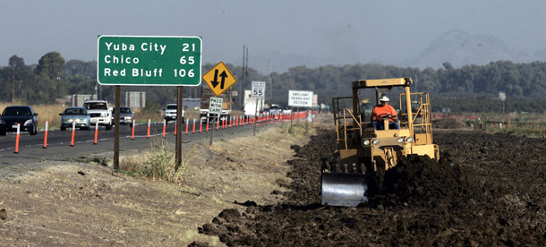 Construction workers widen a road in East Nicolaus, CA. Build America Bonds have proven to be a more efficient way to fund state and local public works projects than tax-exempt bonds, and they prevent a large windfall from the bonds going to wealthy investors. (AP/Rich Pedroncelli)