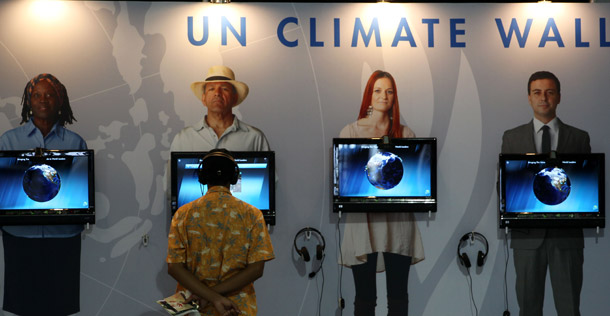 A man looks at an exhibit on climate change during the United Nations Climate Change Conference in Cancun, Mexico, on December 1, 2010. (AP/Eduardo Verdugo)