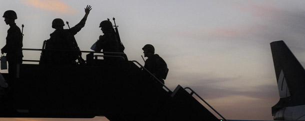 A soldier from the 116th Cavalry Brigade of the Idaho Army National Guard waves back to the crowd as he boards a plane with 350 other soldiers in Boise, ID. Sixty-five retired military chaplains wrote to President Barack Obama earlier this year urging him to maintain the military’s ban on service by openly gay men and women. They claimed that allowing gay men and women to serve openly would compel them to violate their religious principles, such as forcing them to perform same-sex marriages. (AP/Matt Cilley)