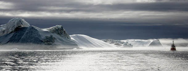 A ship passes by the coast of Greenland where the nearby Sermeq Kujalleq glacier has thinned in recent years. <i>Politico </i>reports that Fox News Vice President Bill Sammon sent an email to staff last December insisting that everyone at the station refrain from recognizing the global scientific consensus on man-made global warming. (AP/Michael Kappeler)