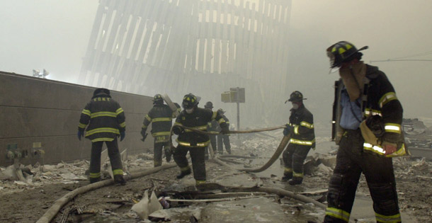 New York City firefighters work amid debris on Cortlandt Street after the terrorist attacks on September 11, 2001. Congress approved a $4.3 billion aid package to 9/11 workers yesterday after legislative delay and scant media attention to the issue. (AP/Mark Lennihan)