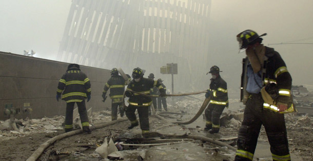 New York City firefighters work amid debris on Cortlandt Street after the terrorist attacks on September 11, 2001. Congress approved a $4.3 billion aid package to 9/11 workers yesterday after legislative delay and scant media attention to the issue. (AP/Mark Lennihan)