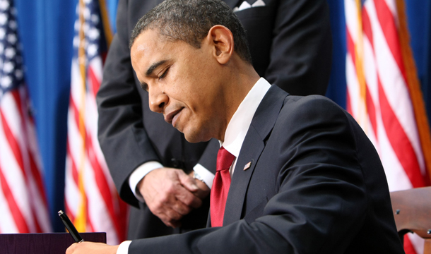 President Barack Obama signs the American Recovery and Reinvestment Act, Tuesday, February 17, 2009. As part of the recently announced tax framework agreement between the president and Republicans in Congress, the Making Work Pay credit, originally passed as part of the Recovery Act, will be allowed to expire as scheduled at the end of this year, raising taxes for about 25 million working people. (AP/Gerald Herbert)