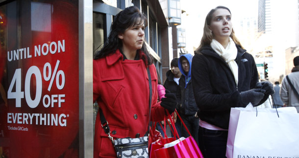 Shoppers walk out of the Express women's apparel store on Chicago's Magnificent Mile. Expansion of personal consumption and an improvement in U.S. trade competitiveness led today’s economic growth numbers. (AP/Charles Rex Arbogast)