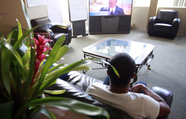 A foster care resident watches television at the Gay & Lesbian Center in Los Angeles, which recently received a $13.3 million federal grant to help more homeless gay teens. Around 320,000 to 400,000 gay and transgender youth out of 1.6 to 2.0 million  total homeless youth experience homelessness at some point each year. (AP/Damian Dovarganes)