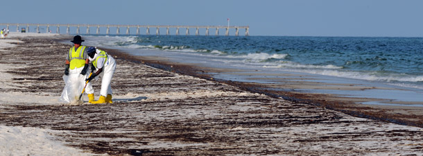 Crews work to clean up oil from the Deepwater Horizon oil spill washed ashore at Pensacola Beach in Pensacola, FL. The American Petroleum Institute rashly advocated a speedy return to expanded offshore oil drilling even though the National Commission on the BP Deepwater Horizon Oil Spill and Offshore Drilling will today issue its recommendations for additional safeguards for future offshore oil production. (AP/Michael Spooneybarger)