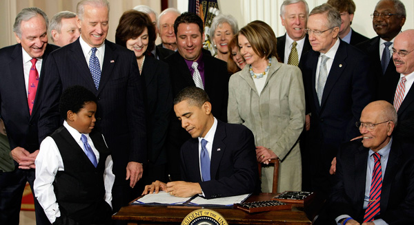 President Barack Obama signs the Affordable Care Act in the East Room of the White House on March 23, 2010. The newly enacted ACA is estimated to cover an additonal 32 million people. (AP/J. Scott Applewhite)