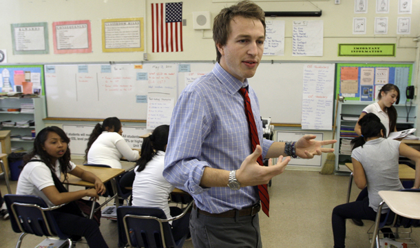 English teacher Nicholas Melvoin walks around his classroom as he teaches at Edwin Markham Middle School in the Watts district of South Los Angeles. Seniority-based teacher layoffs disproportionately affect schools such as those in South and Central Los Angeles because these high-poverty schools tend to have a higher proportion of novice teachers. (AP/Reed Saxon)