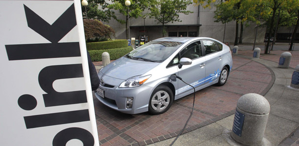 A Toyota Prius Hybrid charges during the unveiling of the Blink electric vehicle charging station on September 22, 2010, in Portland, Oregon. The administration could use $300 million currently going to Big Oil companies for a “race to the top” pilot program to provide 30 communities with grants for up to $10 million to build electric vehicle recharging infrastructure and improved batteries. (AP/Rick Bowmer)