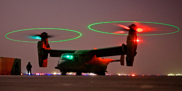 A V-22 Osprey tilt rotor aircraft taxies behind the leader during a mission in western Iraqi desert. Canceling this program is one initiative that could help the Pentagon could save around $358 billion by the end of 2015. (AP/Dusan Vranic)