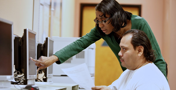 State of California Employment Program Representative Brigitta Croil assists job seeker Freddy Gomez at the Verdugo Job Center in Glendale, California, on February 3, 2011. Unemployment remains extraordinarily high such as communities of color, young job entrants, and people with little educational attainment. (AP/Damian Dovarganes)