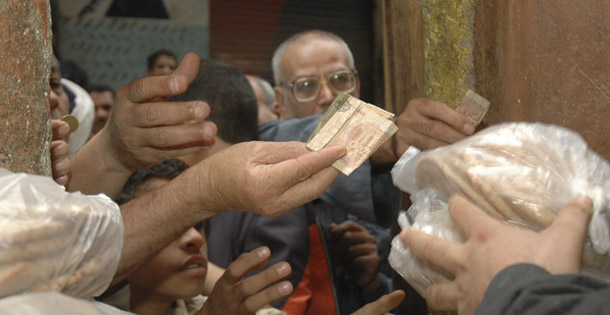 Egyptians buy government-subsidized bread from a bakery in Cairo, Egypt. Egypt has spent $4 billion a year, or 1.8 percent of GDP, on its bread subsidization program in an attempt to insulate the 40 percent of Egyptians living on less than $2 a day from inflation. But prices continue to rise. (AP/Hossam Ali)