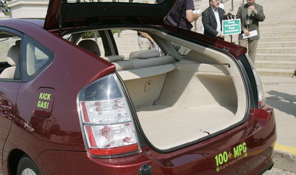 Minnesota state lawmakers unveil the first plug-in hybrid-electric vehicle, or PHEV, to hit Minnesota streets during a news conference at the Minnesota Capitol Building on August 23, 2006. The president has set a fundamental goal to have 1 million plug-in hybrid and all-electric vehicles on the road by 2015, to further reduce oil use. (AP/Jim Mone)