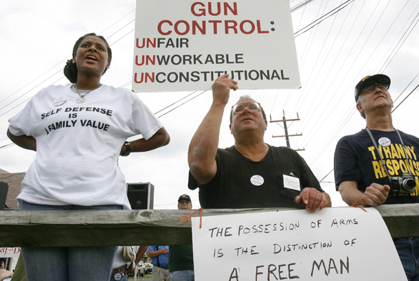 Counter-protesters Kenya Stevens, left, of District Heights, Maryland; Steve Tidwell, of Arlington, Virginia; and a protester who asked not to be named shout their support for gun rights across from a protest of gun-control advocates next to Realco Gun Shop in District Heights on Tuesday, August 28, 2007. (AP/Jacquelyn Martin)