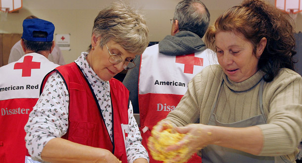 American Red Cross volunteers prepare food in Decatur, Illinois. The tax code allows people to deduct from their income contributions to charitable organizations such as the Red Cross. (AP/Seth Perlman)