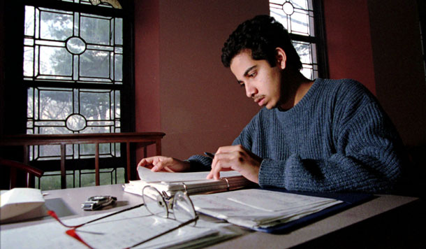 A student studies financial aid documents. Congress should require that colleges show students their estimated financial aid package at least 10 days before enrollment. (AP/Daniel Hulshizer)