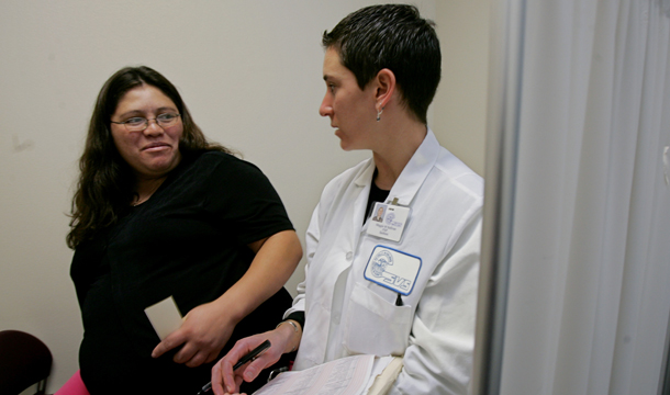 Family nurse practitioner Maggie Sullivan, right, talks with Jasmine Morales, who is three days overdue for the birth of  her baby, at the Clinica de Salud del Valle de Salinas, a community clinic in Salinas, CA. (AP/Paul Sakuma)