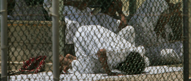 A Guantanamo detainee prays inside the compound of Camp Delta detention center at the Guantanamo Bay U.S. Naval Base, Cuba. (AP/Brennan Linsley)