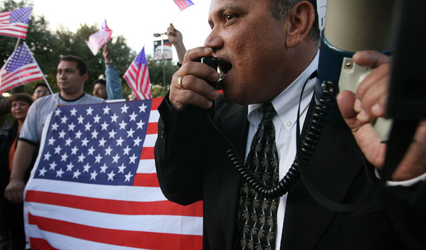 Jorge Rivera leads a rally outside city hall in Farmers Branch, Texas. The town has incurred more than $4 million since 2006 in legal fees to defend its anti-immigration statute. (AP/ Rex C. Curry)